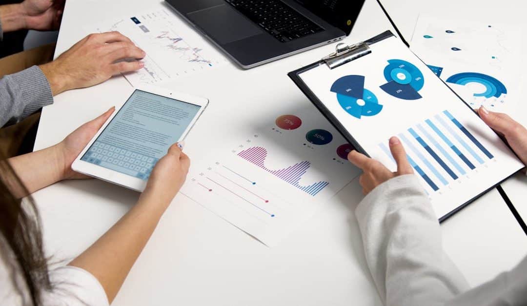 team-analyzing-financial-charts-and-digital-reports-during-a-business-meeting